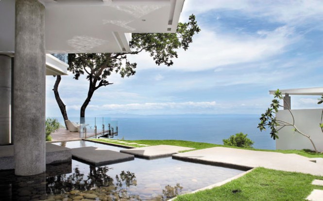 The house boasts a spectacular view of the blue Costa Rican waters, and parts of it even float atop a rock-filled pond.
