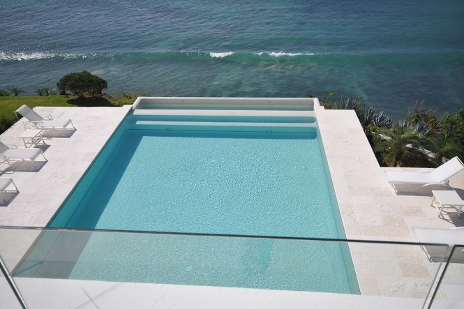 The modern pool almost spills out to the bay.