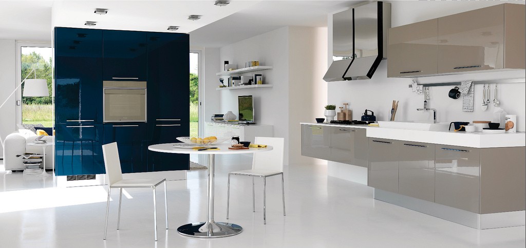 kitchen12 This beige and white kitchen is very open and connected to the rooms adjoining it. It only seems to be separated by the deep blue (a nice color choice) large cupboard area.