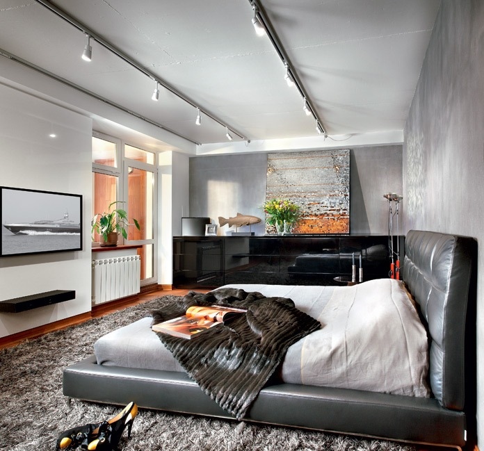This soft black leather bed is a wonderful statement piece, but you don't have to break the bank to get a similar look; there is a whole host of convincing leatherette beds on the market at a fraction of the price of their cow hide cousins. The low-level platform style of this piece is complimented by a long sleek sideboard and floating shelf in the same color.