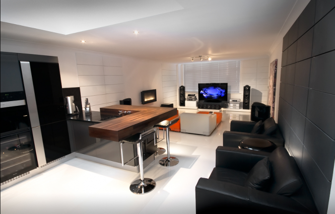 In the kitchen the homeowners wanted something to compliment the forward thinking design of the rest of their home, so installed a wall of appliances, as well as a bespoke floating breakfast bar holding vertically mounted taps.