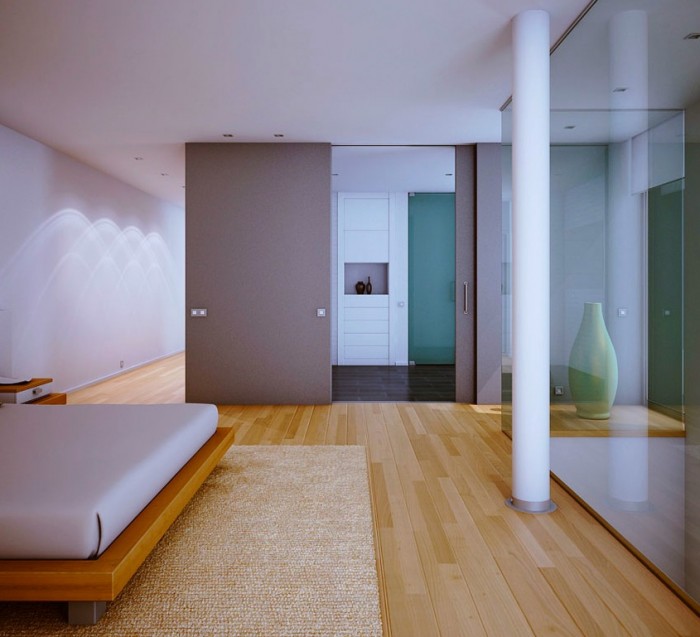 An ensuite bathroom and dressing area lies beyond a large sliding door