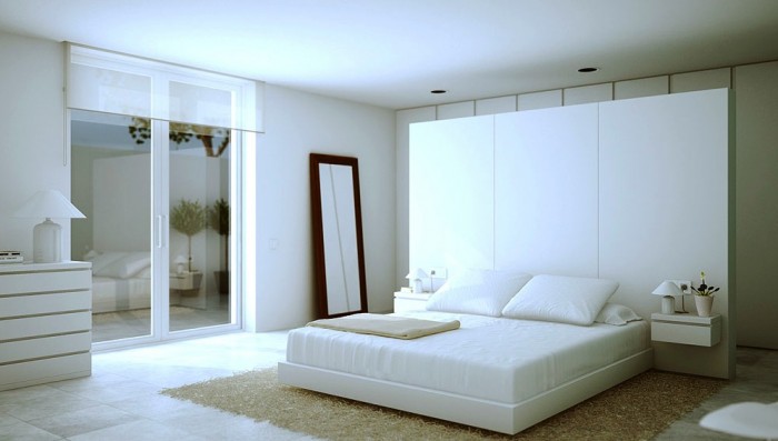 An oversized headboard acts as a dividing wall between the sleeping and dressing areas.