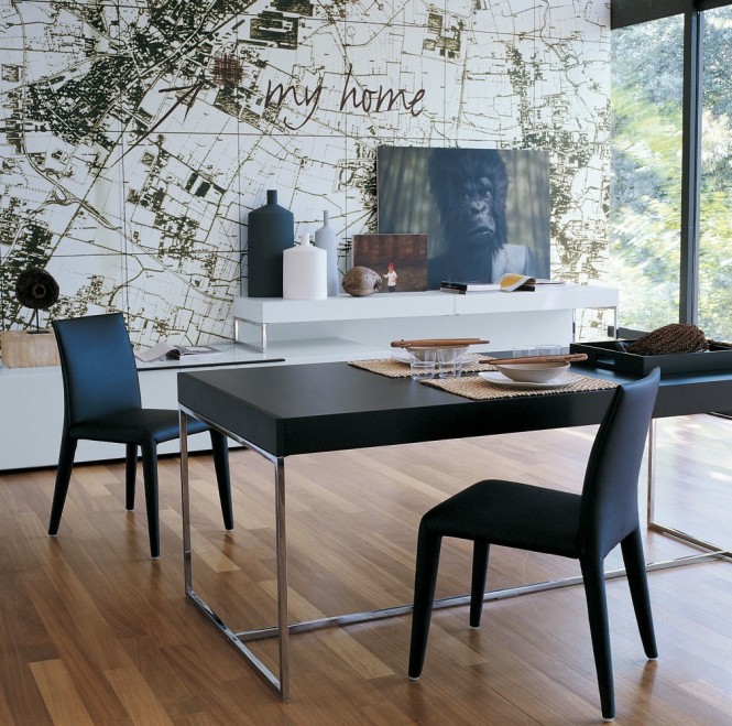 The sleek lines of this modern dining suite contrasts against the organic shapes that lie beyond the glass, though a map wall mural connects the décor to it's surroundings.