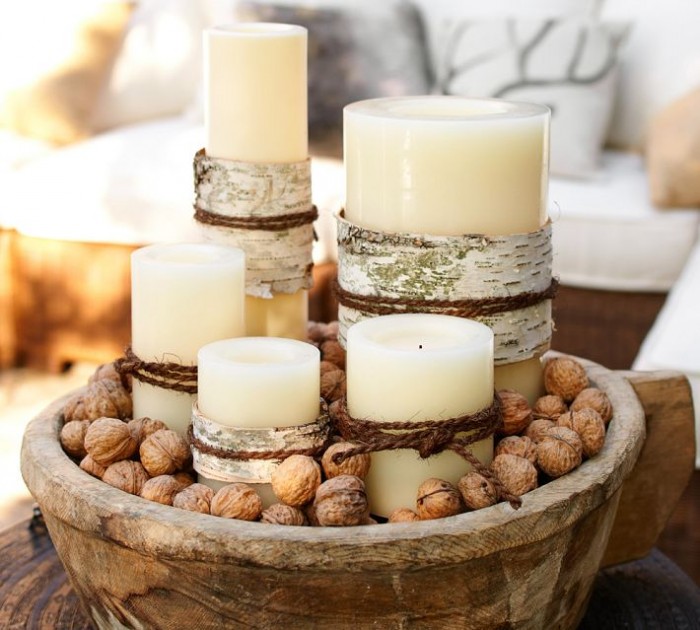 A modern décor often doesn't call for traditional decorations, this Christmas centerpiece offers a charming solution with its natural elements of rustic wood bowl, candles and nuts.