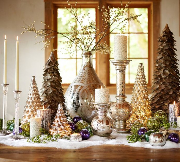 This tablescape gets it right with varying heights of decorative trees, candle holders and tiny décor items.