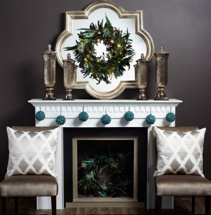A contemporary mantel gets dressed with a simple silver wreath flanked by two stark Christmas trees.