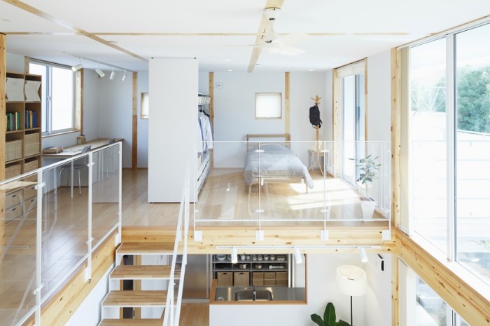 Wood insets in the ceiling and walls use line in its most simplistic form to create interest. Glass panels used as railing around the loft area allow light to travel through space.