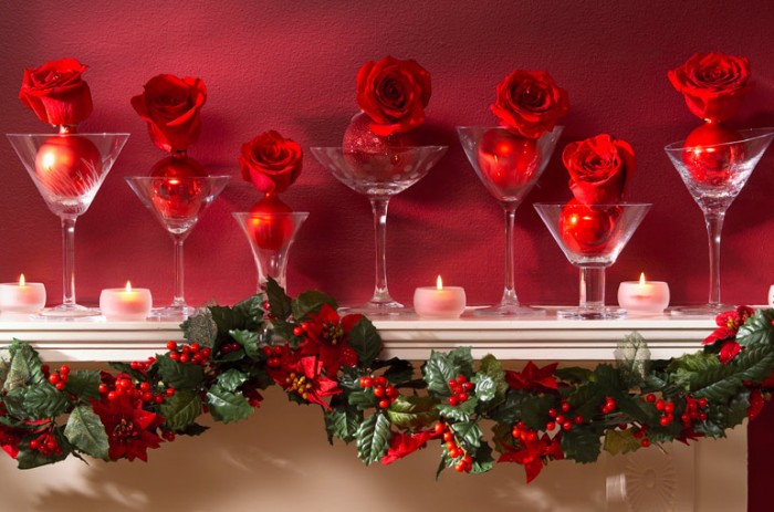 Sometimes simplicity makes the biggest impact. This Christmas mantel is dressed with common martini glasses with an inset of ornament and rose surrounded by petite votives and draped with a garland of traditional mistletoe.