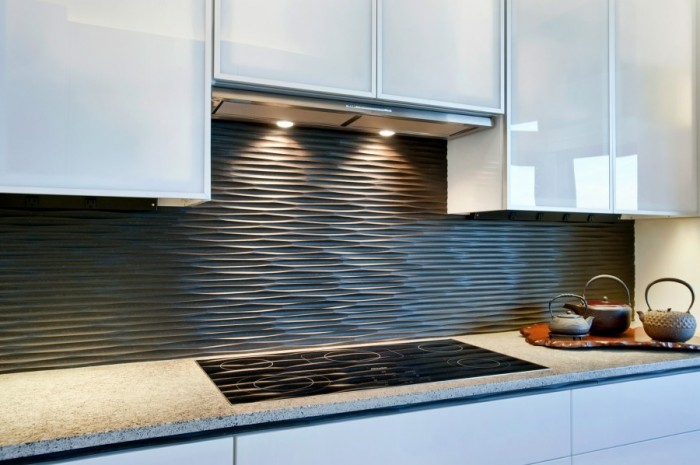 This wavy backsplash in graphite adds texture and interest to a white kitchen.