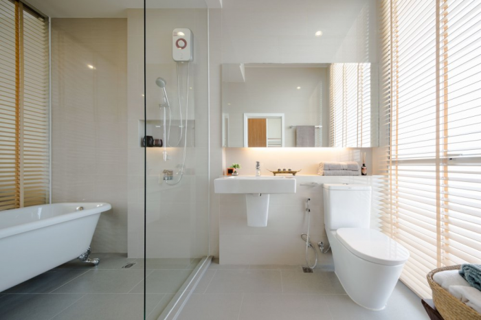 The bath is full of natural light as well from a large wall of windows.