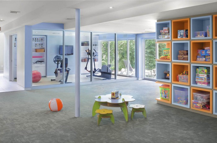 Multi-activity space such as this are a terrific way to make the most out of a basement. Parents can watch kids at play while working out in the home gym.