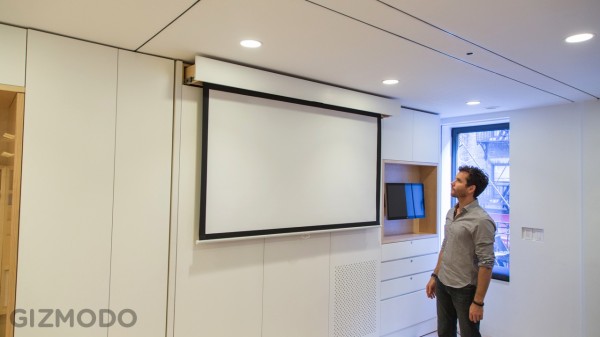 A full-size flat screen pulls out and down from the wall unit.