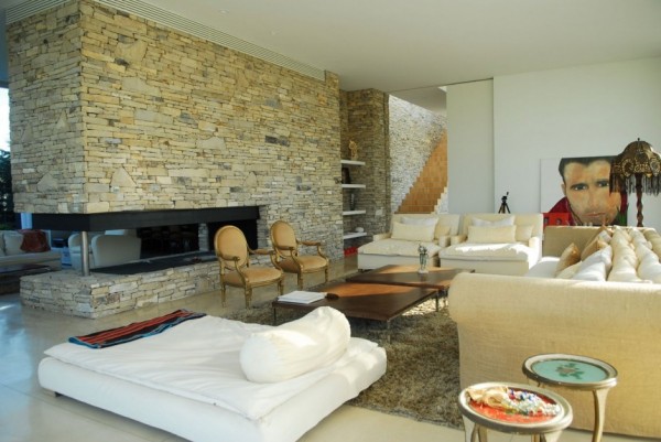 Open Plan living featuring stone wall and fireplace