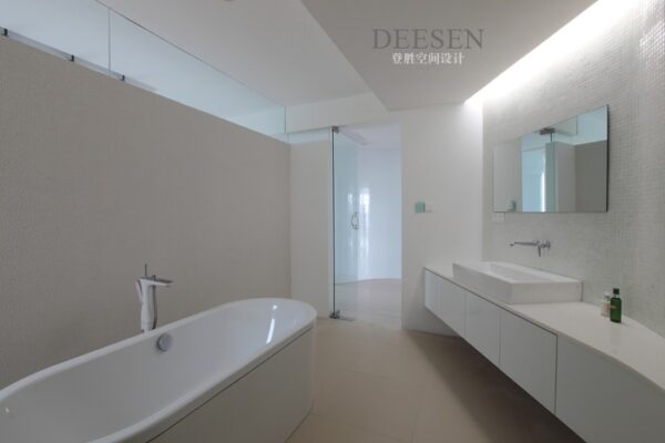 bathroom with elongated tub and simple basin cabinetry