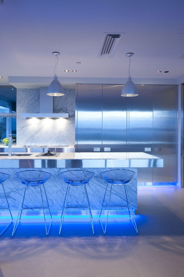 The designer chose blue LED lighting to infuse this modern kitchen with almost underwater-like ambiance.