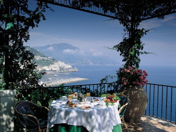 brunch in dappled sunlight on terrace with coastal views
