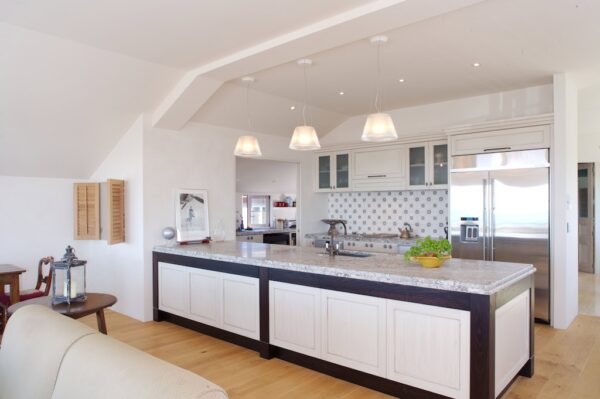 This eclectic modern kitchen is not lacking for charm nor a sunny disposition with a myriad of light sources from windows to fixtures.