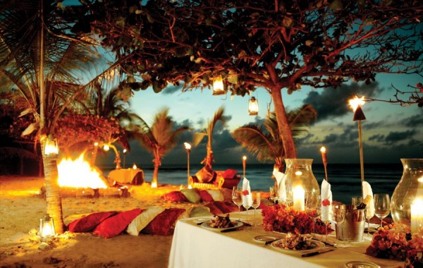 formal dining on the beach with bonfire and lantern light