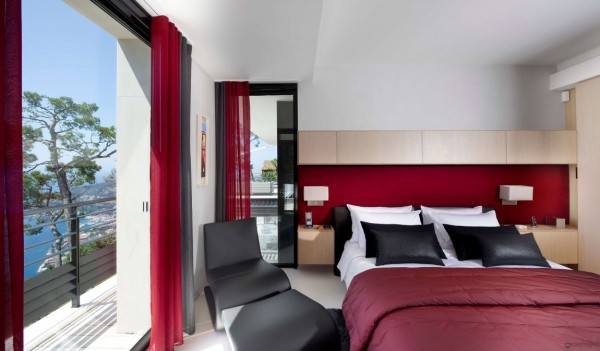 This master bedroom suite is decorated in stunning red and black with views overlooking the Bay below.