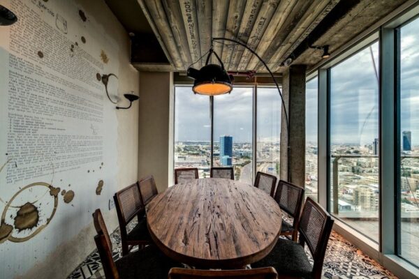 A rustic decorated conference room offers a quaint place to meet with views of the city below and beyond.