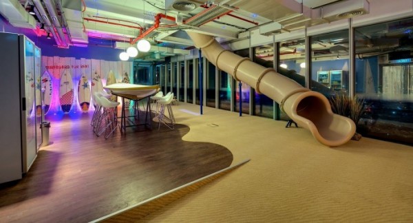 What is a Google office without a playful slide? This cafe/dining area is just one of many throughout the offices offering employees free snacks and drinks.