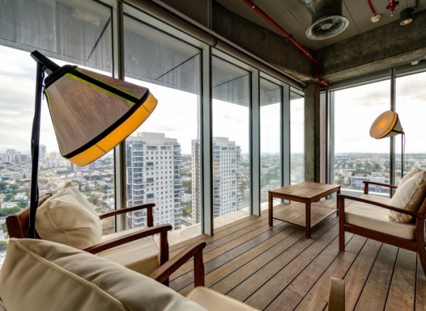 This quite workspace decorated as if a living room looks out over Tel Aviv and the country beyond.