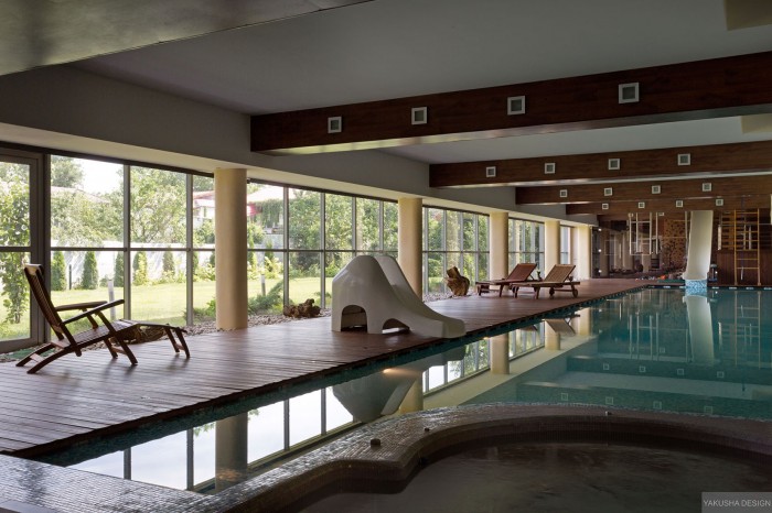 impressive exposed beam indoor swimming pool with garden views daytime