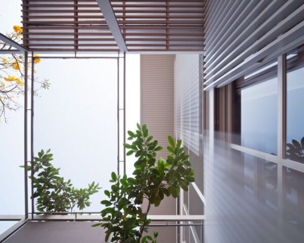 An interior landing is created with walls of glass to stream light and nature indoors.