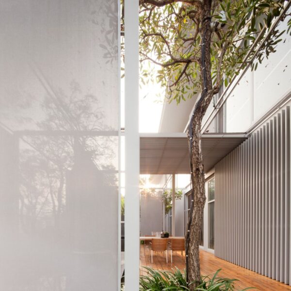 The dining area off the main interior living space boasts a beautifully finished wood floors and metal clad exterior.