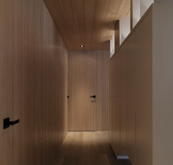 The hallway creates a smooth organic transition between the bedrooms and bathroom.