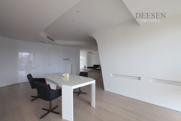 open plan down lit living white table black chairs