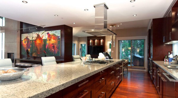 The penthouse's kitchen filled with gourmet appliances, custom wood cabinetry and eat-in dining.