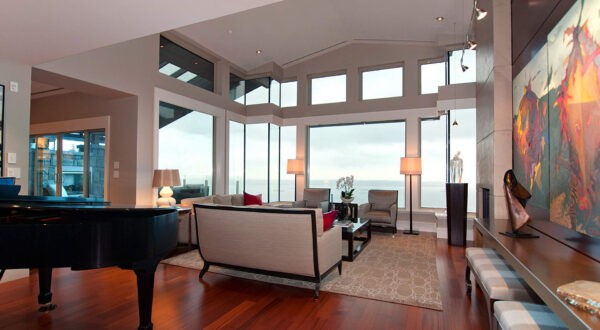 This view of the main open living space shows a massive wall of windows with panoramic views.