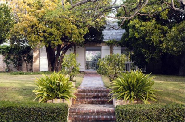 plantation style house paved garden path