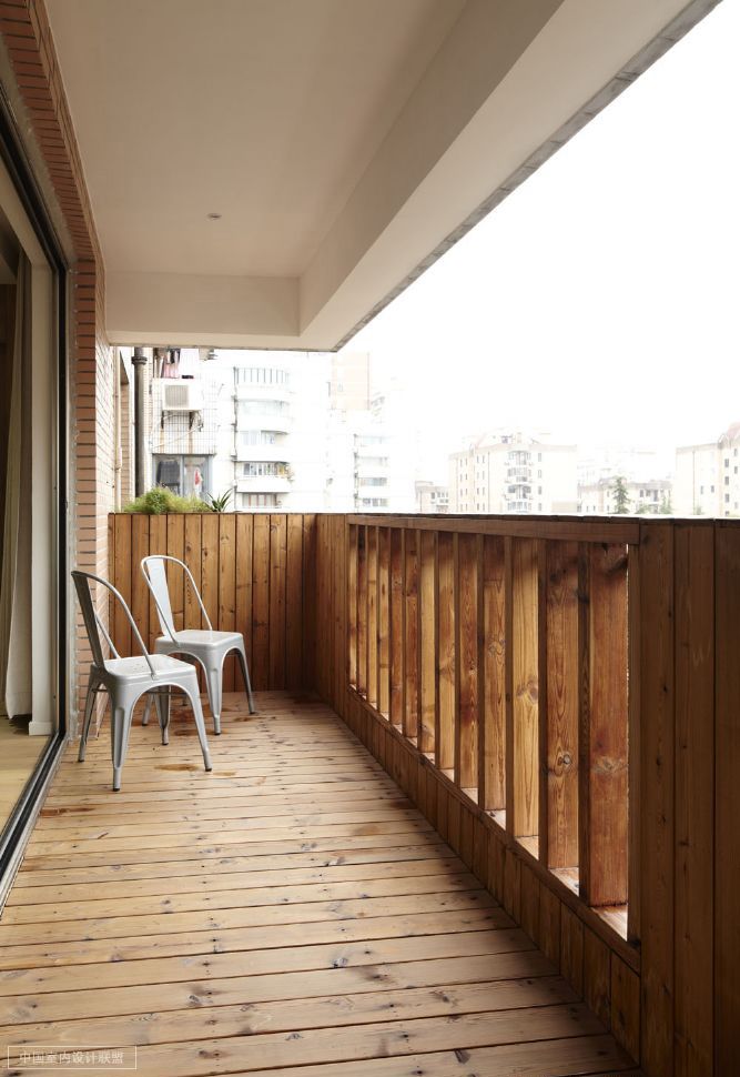 rustic wood heavy balcony with simple modern chairs