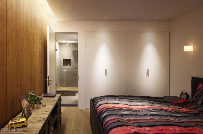 simple bedroom warm wooden cladding with en suite