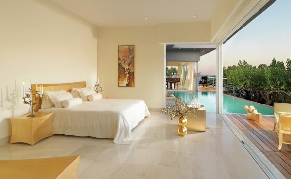 A retracting wall opens the master bedroom to the vast water views beyond and another of the villa's pools.