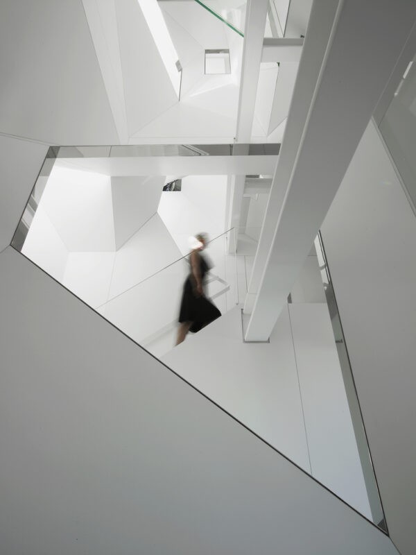 Angular internal stairwell in white with painted steel beams