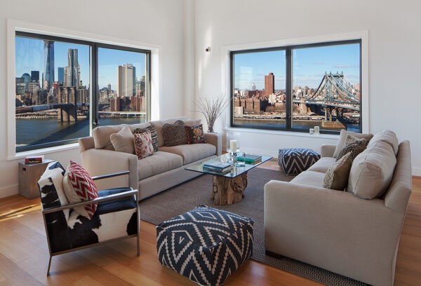 Clock Tower Apartment- neutral sitting area with views to New York City and statement soft furnishings
