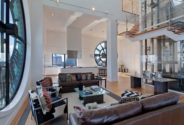 Clock Tower Apartment- open plan living in white with glass panelled staircase and elevator
