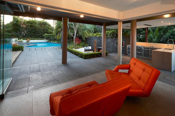Outdoor Living with Sunken Lounge- orange seating lounges undercover with views of garden