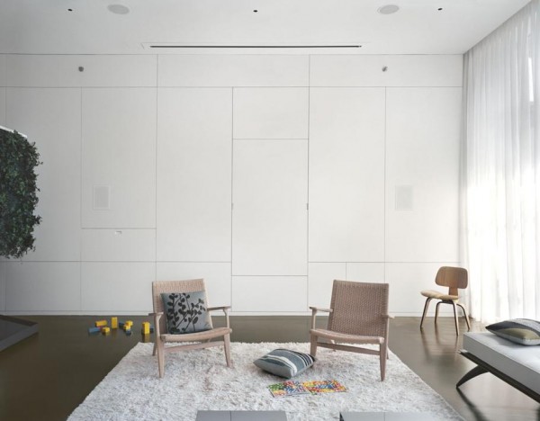 Pulltab Design- White lounge with creative wall storage and  heavily textured area rug