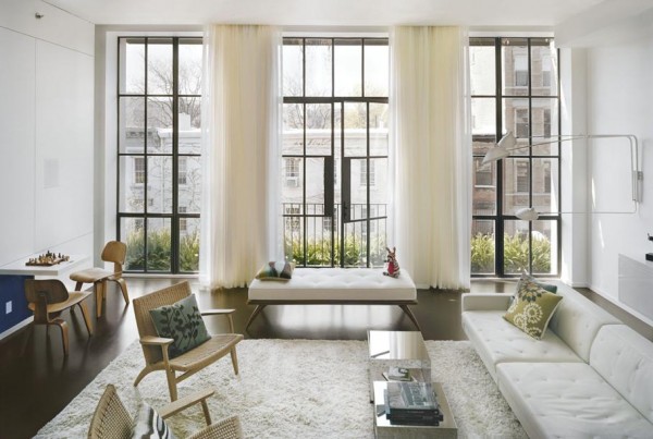 Pulltab Design- naturally lit white lounge with large black framed windows