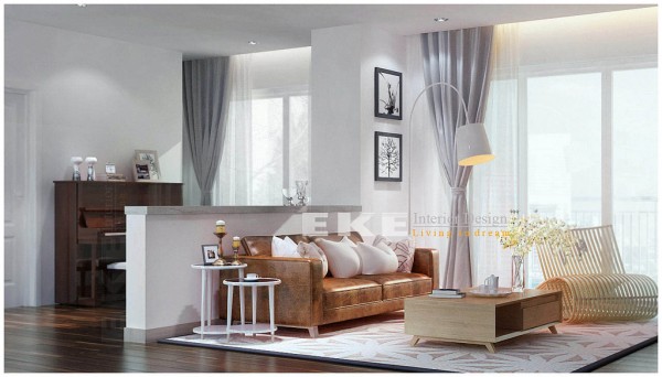 Tuananh Eke's white living area with half height partition and vintage look leather couch