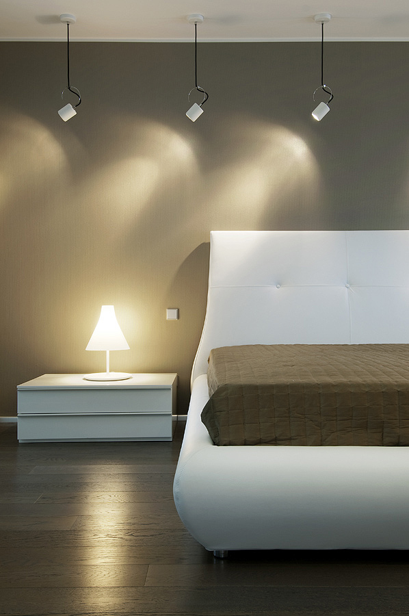 bedroom cool palette with warm accents self illuminating lamp and wood flooring
