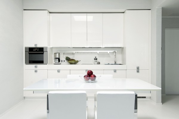 kitchen high gloss white with modern dining setting and minimal accessorizing