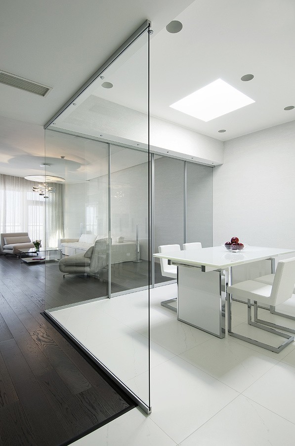 kitchen semi open plan with retractable glass walls and large white floor tiles