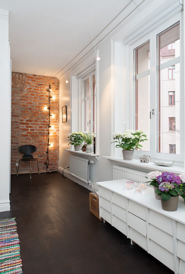 p Urban Apartment with Terrrace- white bedroom with hardwood flooring and exposed brick wall nook
