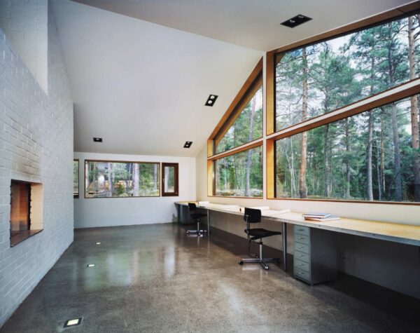 white brick walled workspace with room spanning desks and windows